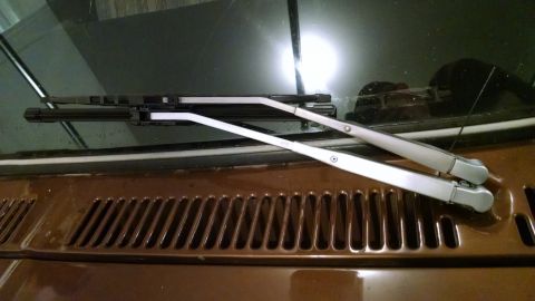1979 Ford F-150 - Close-up view of the windshield wipers and the textured cowl grille on a vehicle.