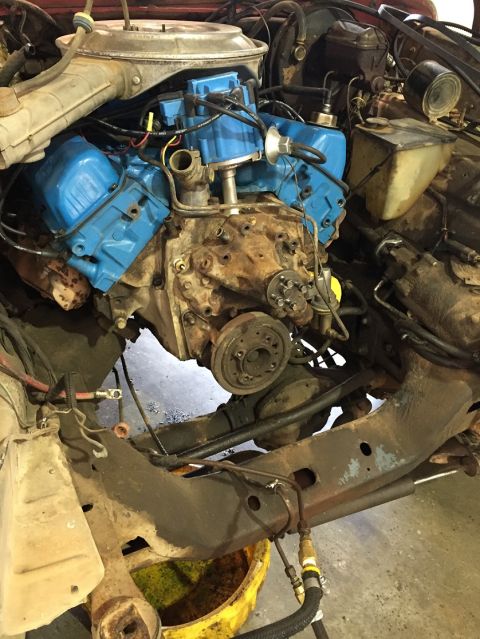 1978 Ford Bronco - The engine bay of a 1978 Ford Bronco is visible, with the V8 engine in focus.