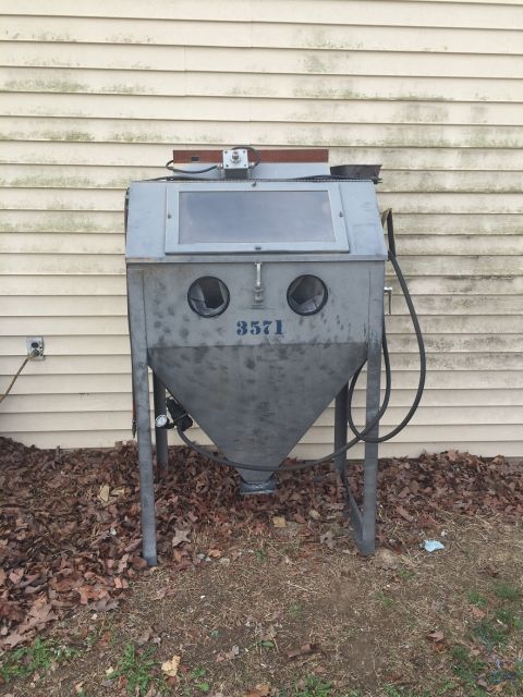 1978 Ford Bronco - A gray sandblaster cabinet is shown outdoors, leaning against a house with vinyl siding. The number 3571 is visible on the front.