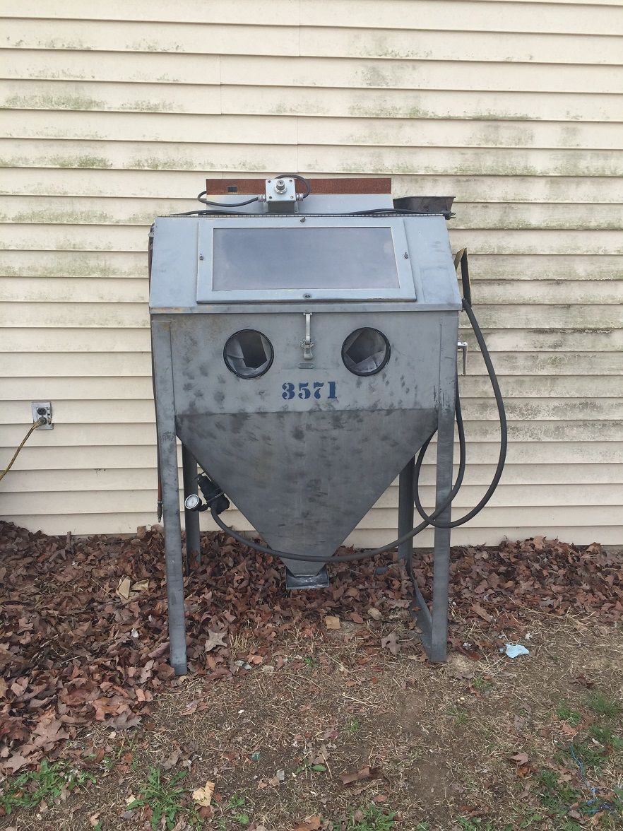 Gray sandblaster cabinet with number 3571 visible
