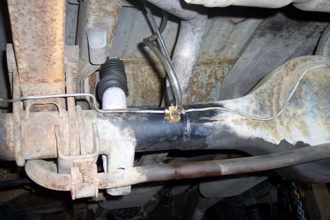 1978 Ford Bronco - Close-up of the rear axle assembly, focusing on the brake lines and suspension components.