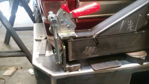 1996 Ford Bronco - Custom rear bumper fabrication in progress, showing a clamp securing metal parts and a measurement marked as 13/16 inches.