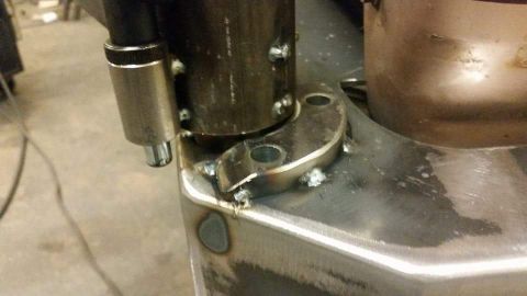 1996 Ford Bronco - Welded metal bracket assembly with a hose clamp on a pipe.