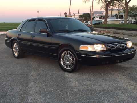 2008 Ford Crown Victoria - A black 2008 Ford Crown Victoria is shown from a three-quarter front perspective.