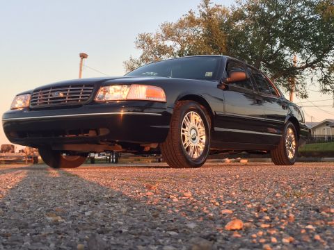2008 Ford Crown Victoria - Black 2008 Ford Crown Victoria seen from a low angle on a gravel surface.