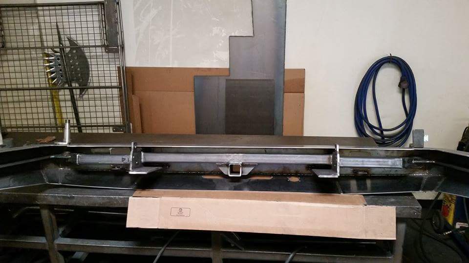 Rear bumper assembly with hitch receiver