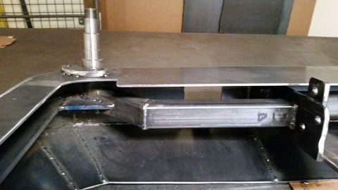 1996 Ford Bronco - Unidentified metal part with a spindle, possibly from a vehicle chassis or suspension system.