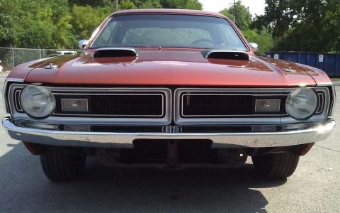 1971 Dodge Dart - Front view of a red 1971 Dodge Dart, showing its distinctive grille and dual hood scoops.