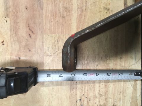 1993 Ford Bronco - A drop pitman arm is measured, showing its dimensions on a wooden background.