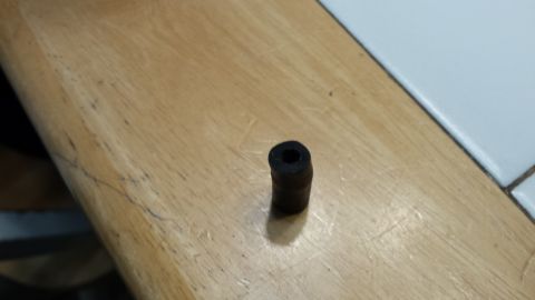 1976 Ford Ranchero - A close-up of a rubber grommet, likely a replacement part, rests on a wooden surface.