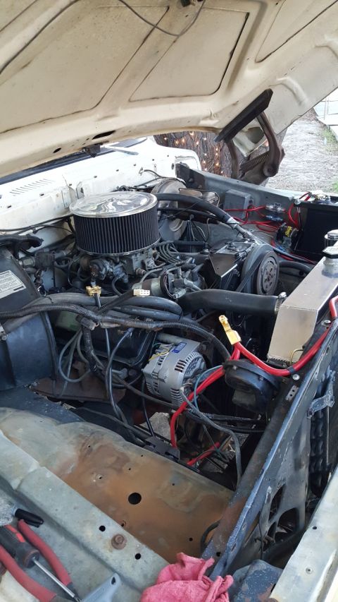 1978 Ford Bronco - Close-up of a modified engine bay in a classic vehicle, featuring an aftermarket air cleaner, alternator, and custom wiring. The engine app…