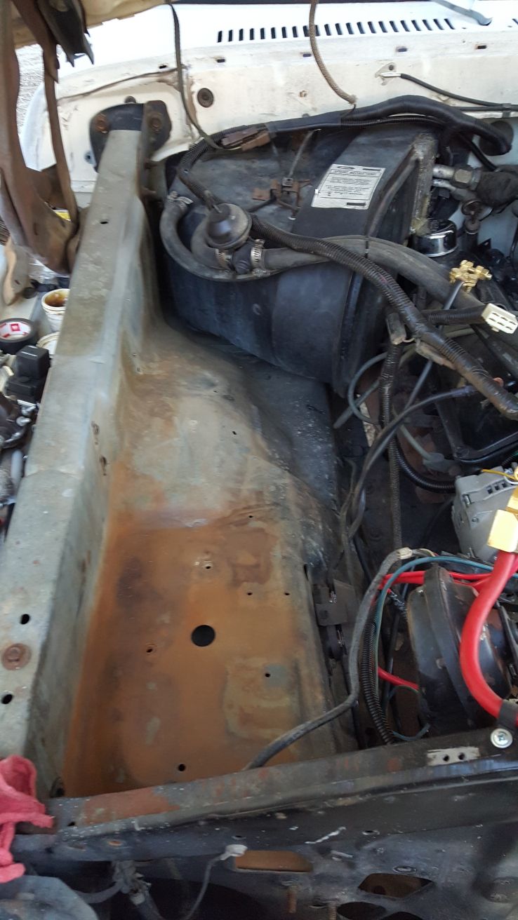 1978 Ford Bronco engine bay with visible rust on firewall and heater box.
