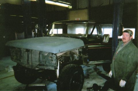 1978 Ford Bronco - A 1978 Ford Bronco is seen in a workshop with its hood removed, undergoing repairs.