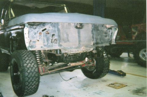 1978 Ford Bronco - Vehicle front end disassembled, revealing the engine bay and suspension components during a build.