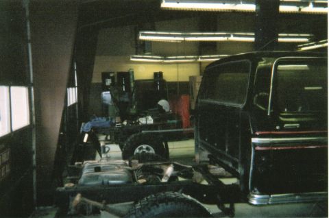 1978 Ford Bronco - A Ford Bronco is undergoing maintenance in a garage, with its body separated from the chassis.