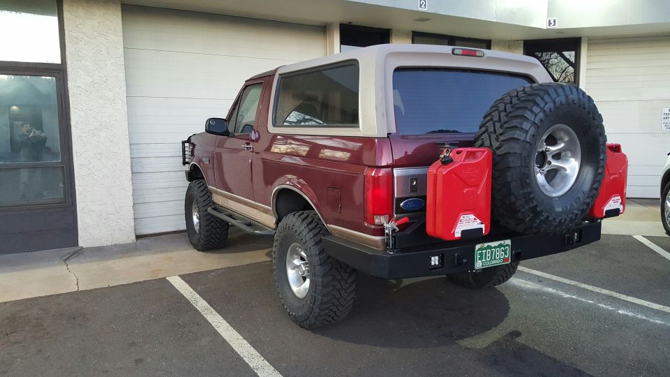 1996 Ford Bronco rear passenger side view with spare tire and jerry cans.