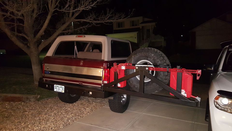 1996 Ford Bronco rear view with spare tire, jerry cans, and hi-lift jack on carrier