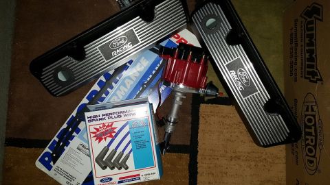 1978 Ford Bronco - A collection of Ford performance parts, including two black Ford Racing valve covers, a red distributor, and a box of high-performance spar…