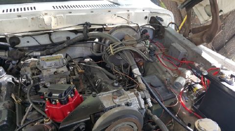 1978 Ford Bronco - This is a close-up view of the engine bay of a vintage Ford truck or SUV, likely from the late 1970s or early 1980s. The image shows a carb…
