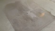 1996 Ford Bronco - The image shows the interior floor of a vehicle, likely a 1996 Ford Bronco, with a tan carpet. Several circular indentations or holes are v…