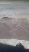 1996 Ford Bronco - The driver's side door of a dark colored 1996 Ford Bronco is shown lying flat on the ground, possibly during a restoration project. The doo…
