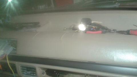1996 Ford Bronco - A close-up view of a cracked dashboard in a vehicle, with a set of keys and tools resting on top. The dashboard appears to be a light tan c…