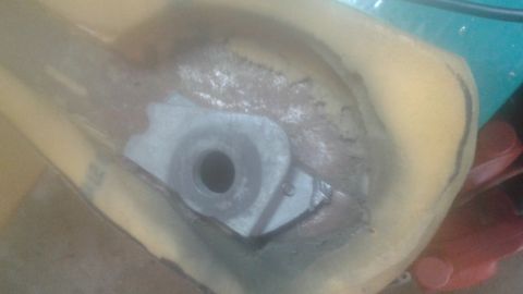 1996 Ford Bronco - A close-up view shows a metal bracket with a circular opening, likely a mounting point, embedded within a yellow foam-like material. The br…