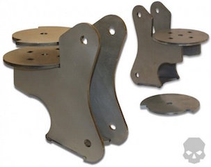 1981 Ford Bronco - Two sets of raw metal suspension brackets are shown, one set assembled and the other disassembled. The assembled set features a main bracke…