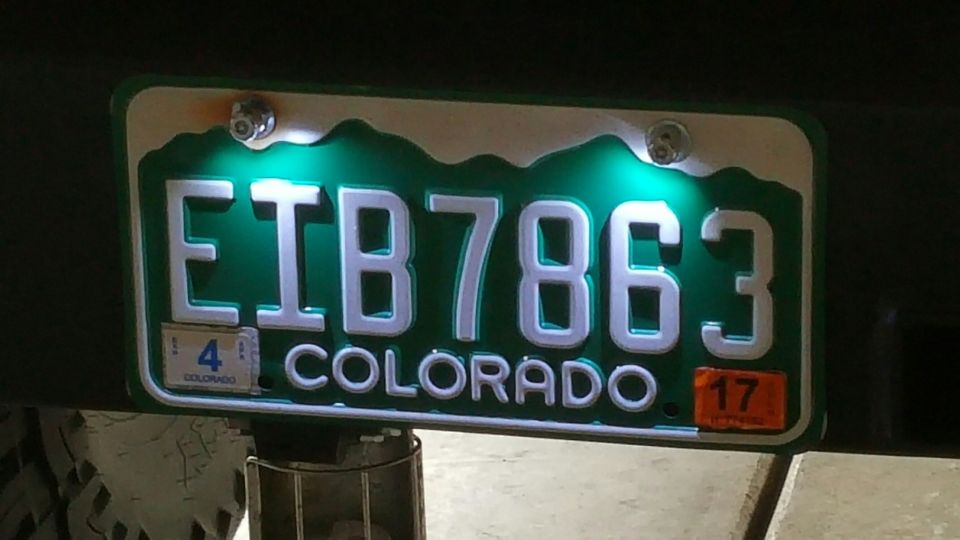 Colorado license plate E1B7863 with green illumination