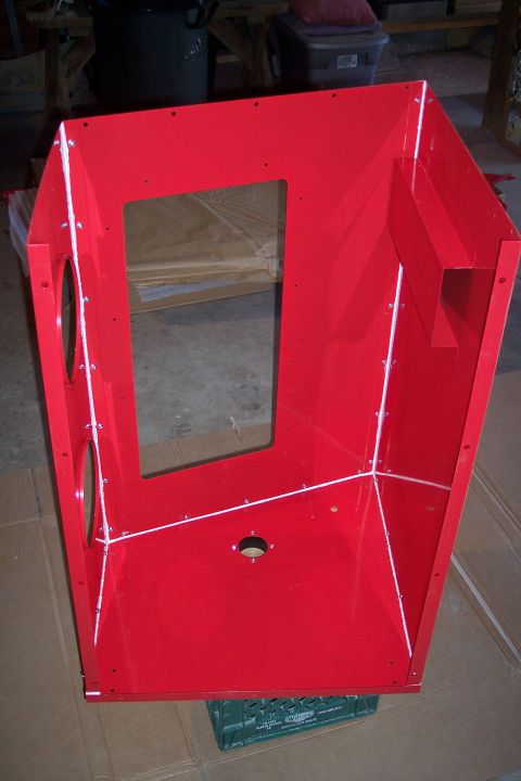 1990 Ford Bronco - A bright red, open-top metal enclosure with a rectangular window opening is shown. The enclosure is supported by a green plastic crate and…