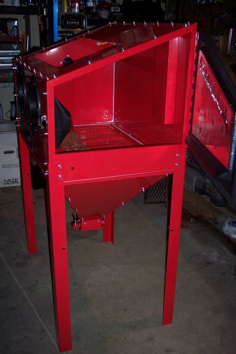 1990 Ford Bronco - A red sandblasting cabinet with a clear door and a metal grate inside stands on four legs. The cabinet is open and shows the interior where…