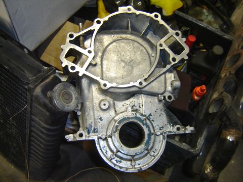 1971 Ford Ranchero - A close-up, overhead view of a disassembled engine component, likely a timing cover or oil pan, with a radiator visible to the left. Severa…