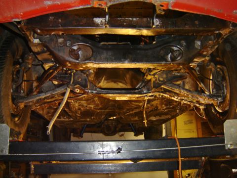 1971 Ford Ranchero - Underside view of a classic vehicle, likely a Ford Ranchero, showing the drivetrain and suspension components. The vehicle appears to be un…