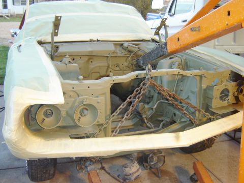 1971 Ford Ranchero - The front end of a classic car, possibly a Ford Ranchero, is shown disassembled and prepped for painting. The engine bay is exposed, with c…