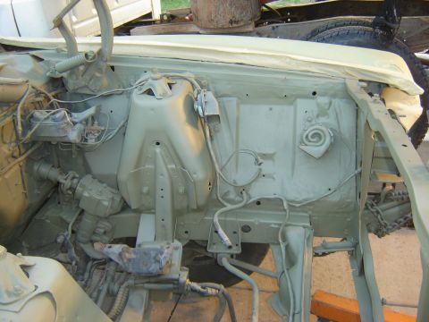 1971 Ford Ranchero - The engine bay of a classic vehicle, likely a Ford Ranchero, is shown after being painted a light green color. Various engine components, w…