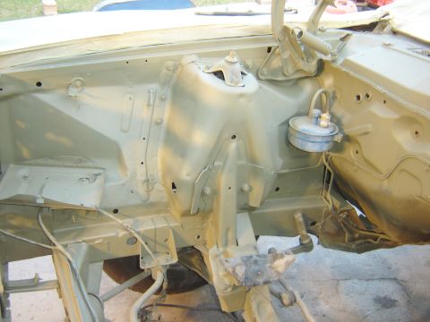 1971 Ford Ranchero - The engine bay of a classic vehicle, likely a 1971 Ford Ranchero, is shown after being painted a light olive green. Components like the mas…
