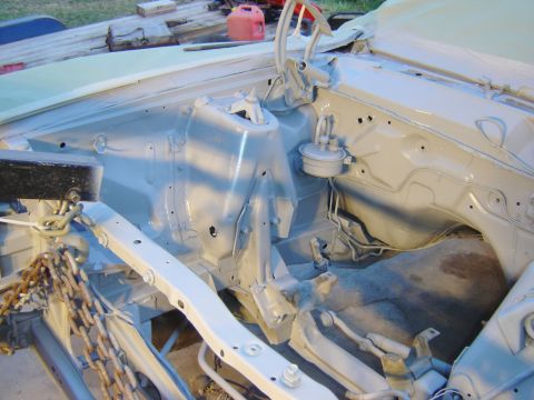 1971 Ford Ranchero - The engine bay of a classic vehicle, likely a Ford Ranchero, is shown after being painted in a light gray primer. Visible components includ…