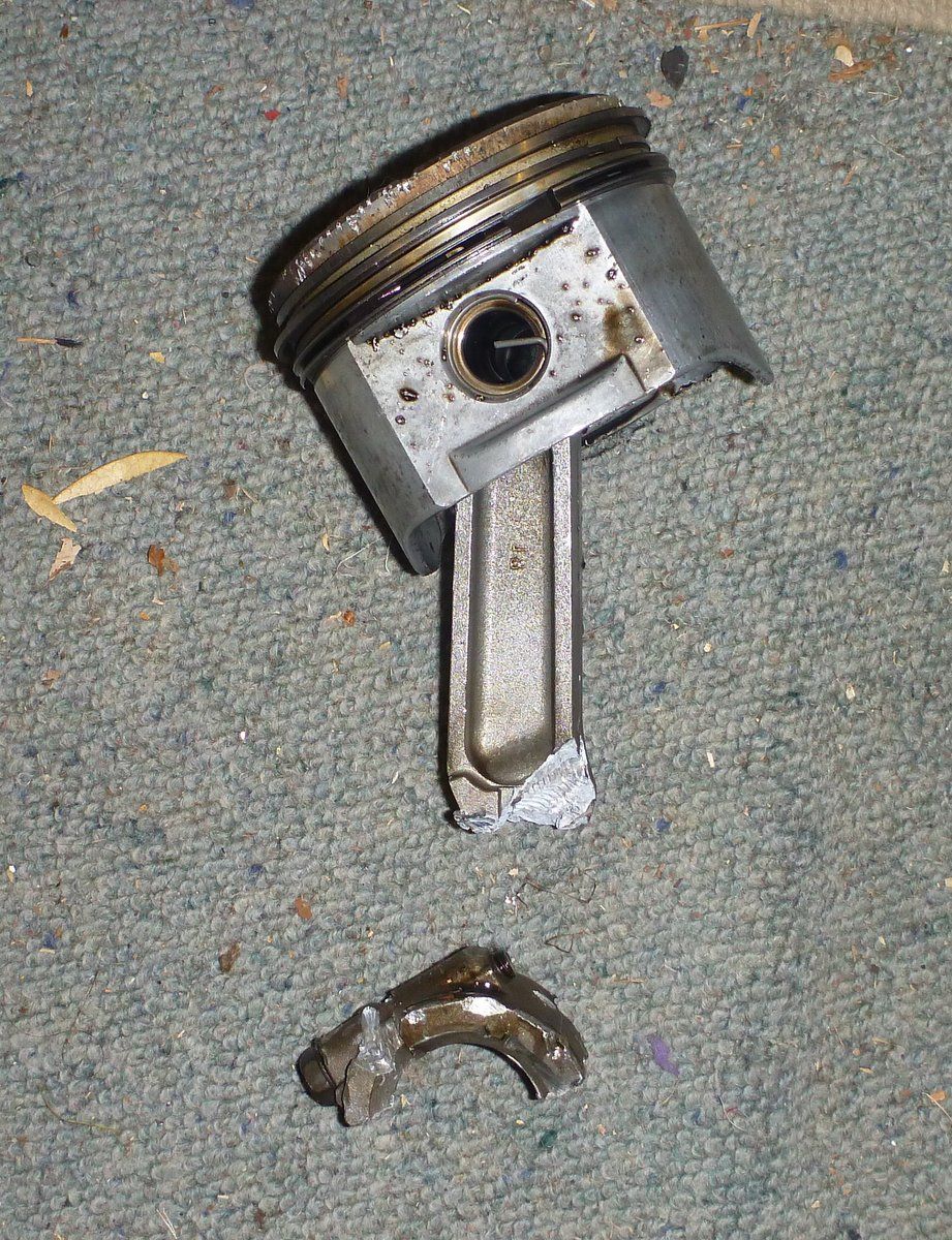 Broken piston and connecting rod on carpet