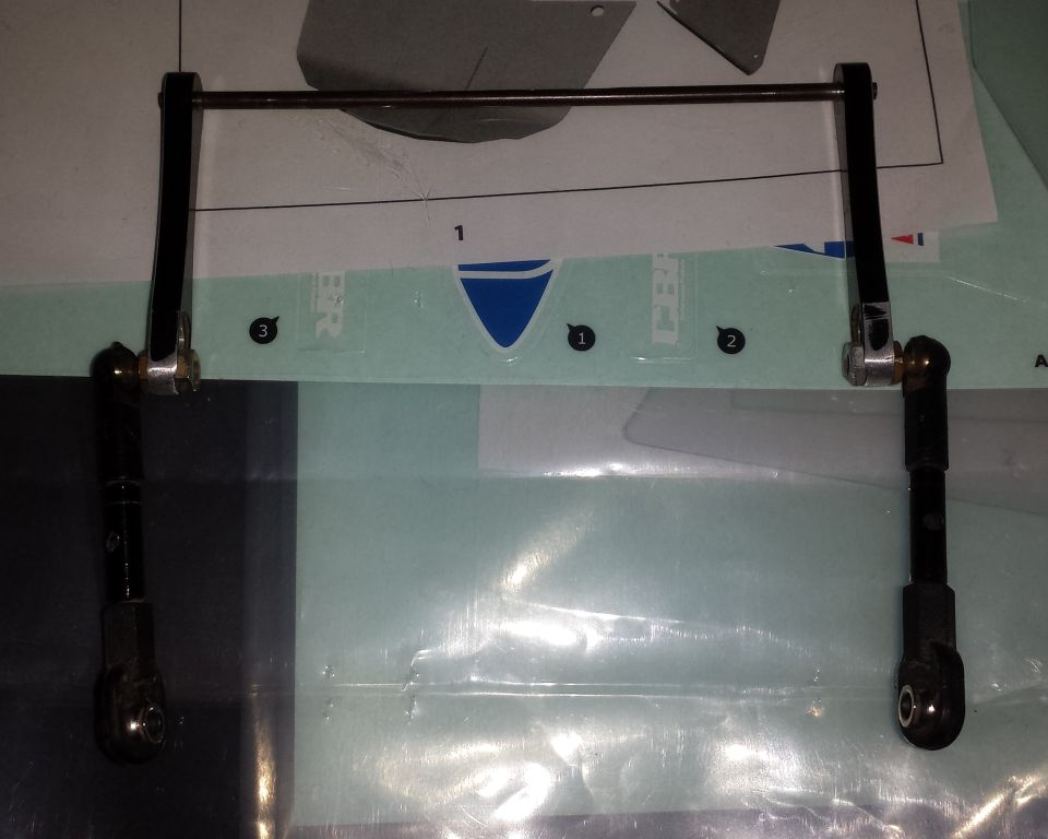 Fabricated sway bar or linkage assembly with rod ends over a printed diagram
