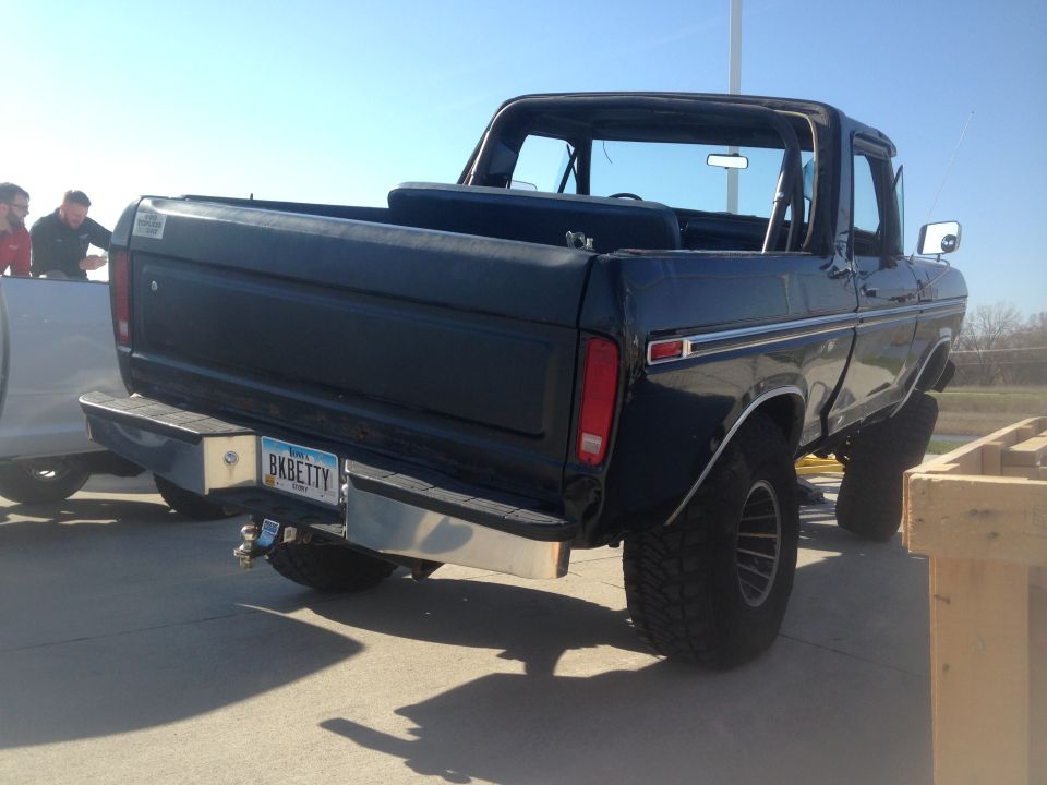 1979 Ford Bronco rear driver's side view, lifted, dark color, custom license plate BKBETTY