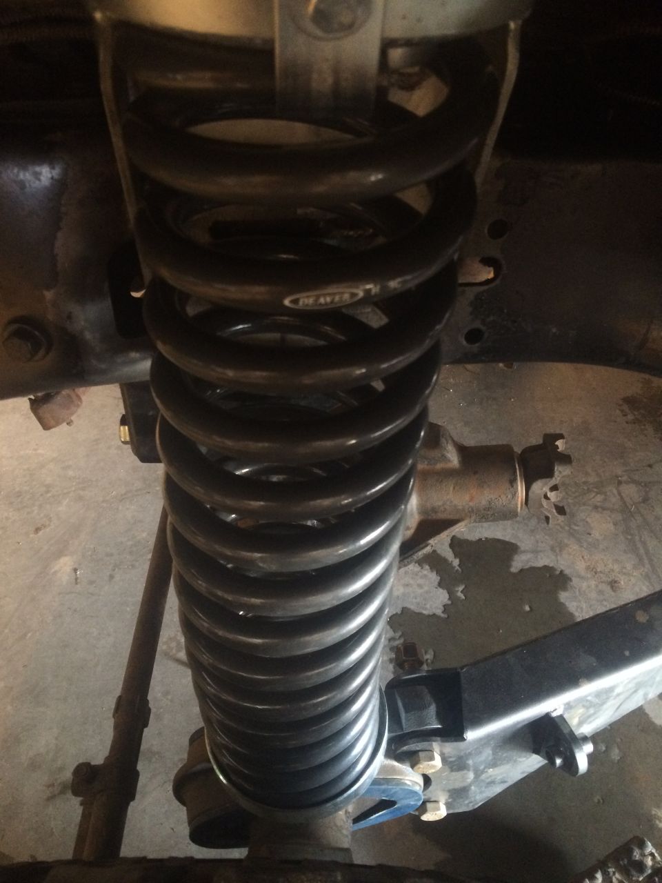 Black Deaver coil spring suspension part on a vehicle.