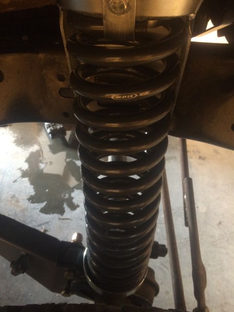 1996 Ford Bronco - A close-up, low-angle shot shows a black coil spring with the brand name "DEAVER" and model number "H58C" visible. The spring is part of a…