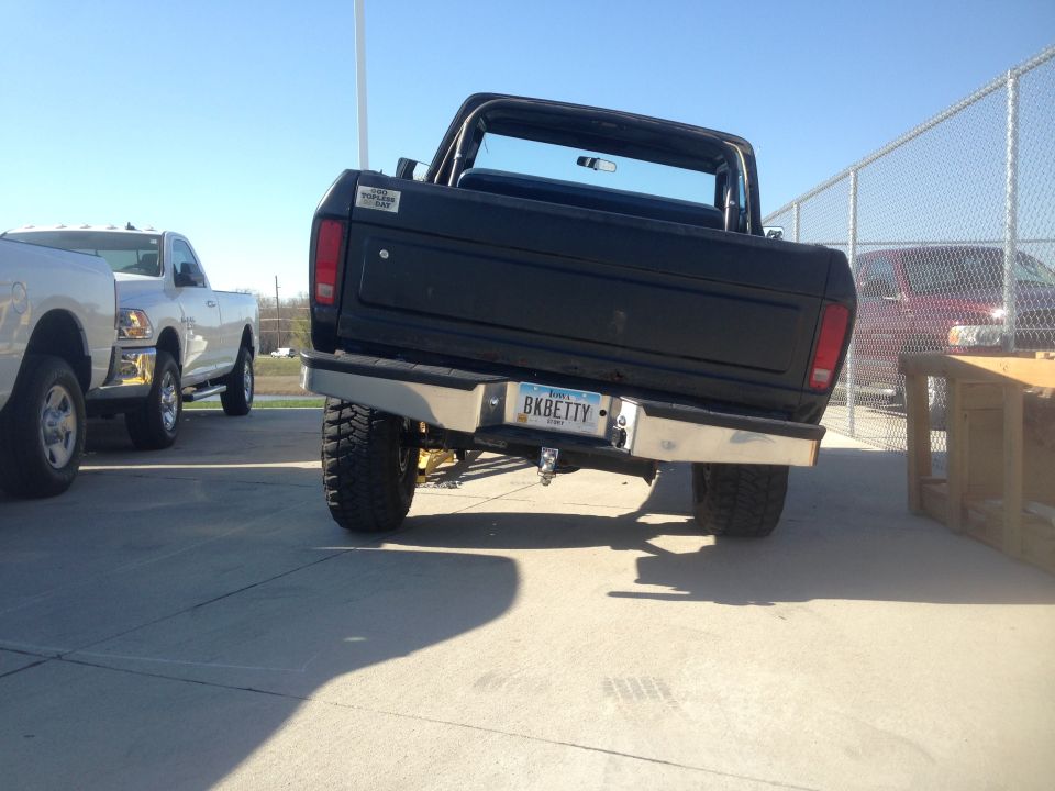 Rear view of a lifted black 1979 Ford Bronco with custom license plate "BKBETTY".