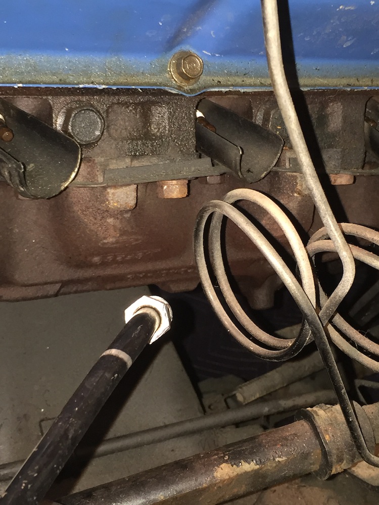 Close-up of engine manifold, spark plug wires, and fuel line