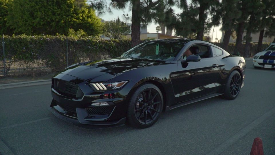 Black Ford Mustang GT350 parked on asphalt