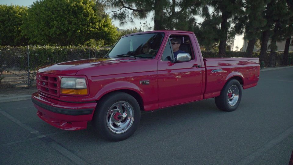 red pickup truck, driver visible
