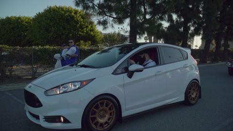 1993 Ford Taurus - White Ford Fiesta ST with aftermarket wheels and a black roof is driving on a street.