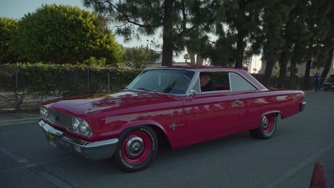 1993 Ford Taurus - A classic red Ford Galaxie coupe is seen from a 3/4 front angle, parked outdoors.