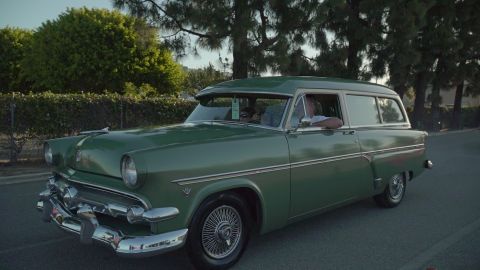 1993 Ford Taurus - A green 1955 Ford Courier sedan delivery is seen from the front three-quarter angle.