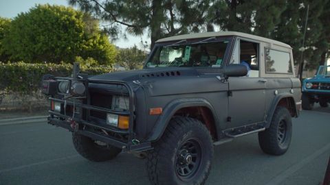 1993 Ford Taurus - A customized Ford Bronco with a winch and off-road tires is parked next to another Bronco.